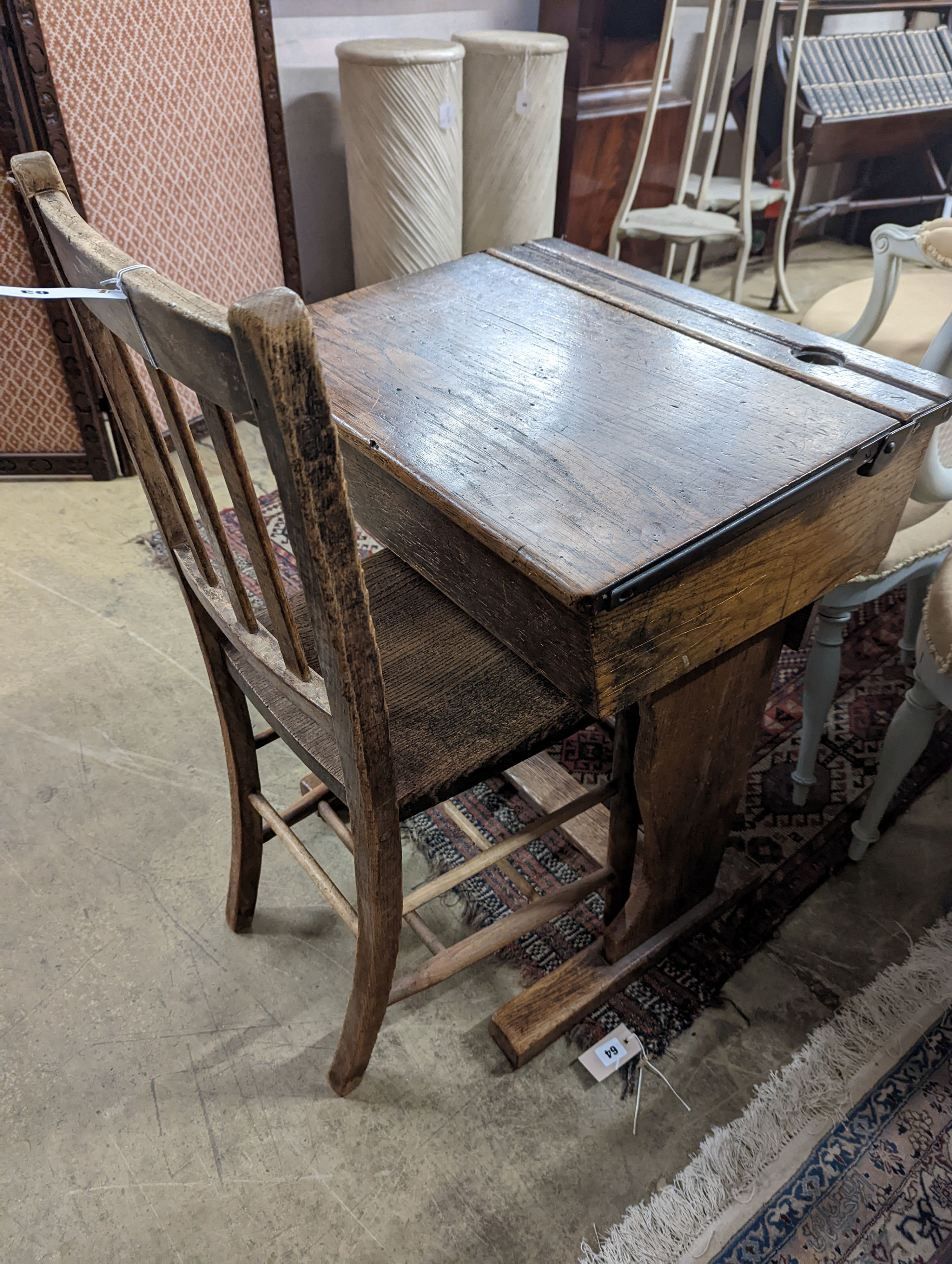 A vintage oak student's desk, width 57cm, depth 46cm, height 71cm with an elm and beech chair